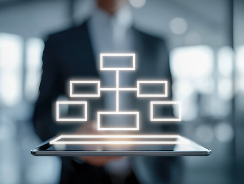 Business professional holding digital tablet projecting illuminated organizational flowchart network structure in modern office environment with blurred background
