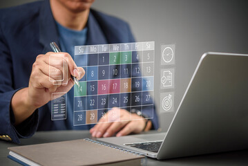 Man scheduling business meeting appointments on digital calendar interface. Focus on efficient planning, organization, daily time management goals, modern productivity technology at office workplace.