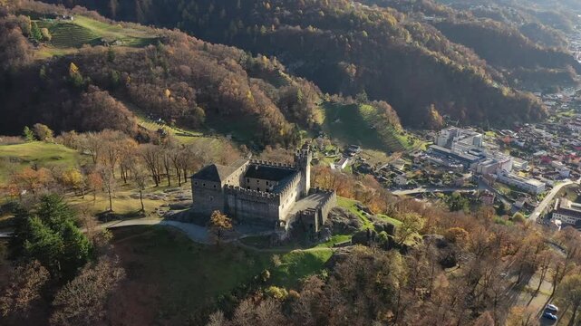 Aerial view of Sasso Corbara castle with its grey stone walls contrasting against the backdrop of the hills, Bellinzona, Ticino, Switzerland.