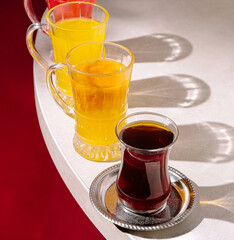 Colorful drinks displayed on a table with vibrant shadows in a cozy setting