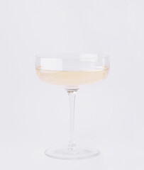 Elegant champagne glass filled with bubbly drink on a clean background
