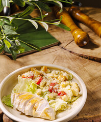 Healthy salad with grilled chicken on a wooden table in a cozy setting