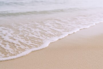 Gentle Ocean Wave Washing Ashore on Sandy Beach: Serene Coastal Scene for Relaxation