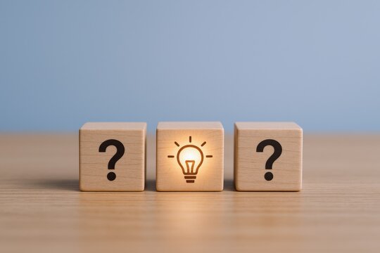 Conceptual Innovation: Wooden Blocks Displaying Question Marks and a Glowing Lightbulb Symbolizing Ideas