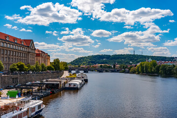 Scenic Vltava River view with Petrin Hill.