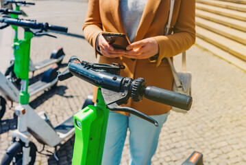 Woman tourist rents electric scooter by phone.