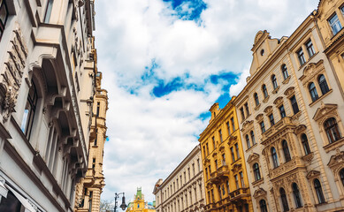 Obraz premium Colorful historic buildings line Prague street.