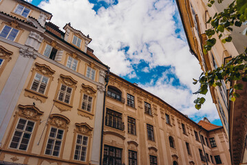 Colorful historic buildings line Prague street.