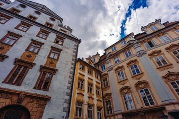 Colorful historic buildings line Prague street.