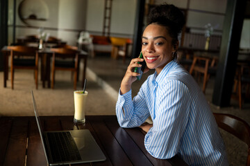 Remote work, communication. African american business woman on a phone call with a laptop working