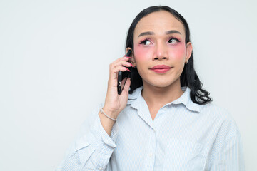 Portrait of a young Thai transgender person on the phone against white background