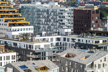 Urban development and modern buildings expanding housing clusters in Bjorvika Oslo Norway, featuring architecture with high contrast and precise structural alignment