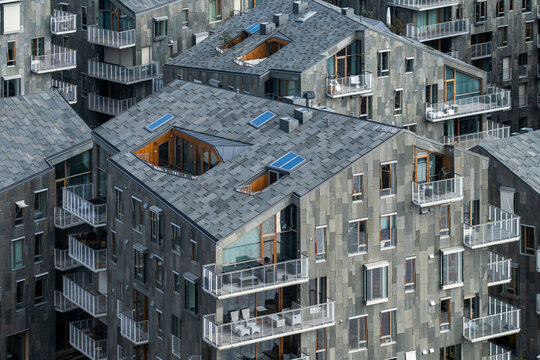 Urban development and modern housing rising among buildings in Bjorvika Oslo Norway, showing architecture with strong contrast and structured geometric forms