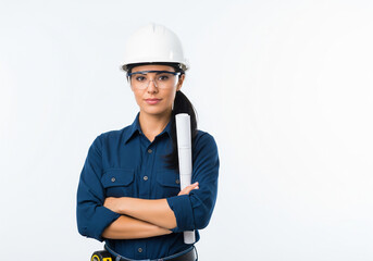 Confident female engineer in hard hat and safety glasses holds blueprints, standing with arms crossed against a white background.