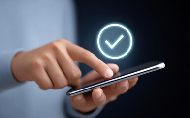 Person hand touching smartphone screen with glowing checkmark icon. technology concept represents satisfaction, approval, success, quality, and task completed