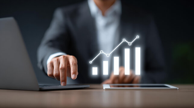 Focused businessman using technology for financial analysis and investment planning. glowing chart shows business growth, profit, and stock market success on digital tablet