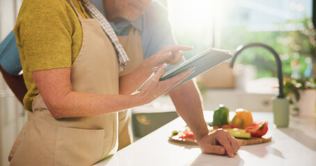 Couple, hands or app with tablet in kitchen for online cooking tutorial or healthy recipe. Apron, man or woman scrolling with technology or ingredients for natural organic food or meal prep in home
