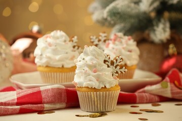 Festive cupcakes with cookies on white table, closeup. Christmas treat