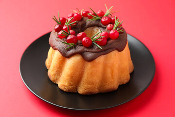 Tasty Christmas cake with cranberries on red background, closeup