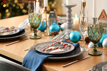 Festive table setting with Christmas decor at home, closeup