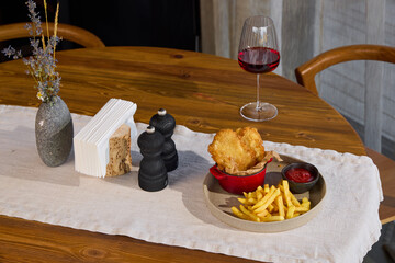 An Elegant and Thoughtful Dining Setup Featuring Fine Wine, Crispy Fries, and Gourmet Cuisine