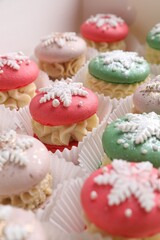 Festively decorated macarons in box, closeup. Christmas treat