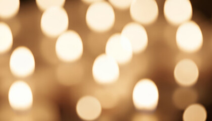 Fully blurred Christmas candlelight with beige and golden tones. Smooth circular bokeh and balanced light distribution arranged for background use.