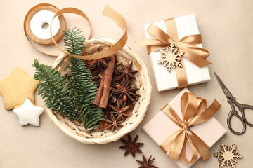 Christmas gifts, spices and festive decor on kraft paper background, flat lay