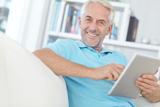 Portrait, happy man or tablet on sofa with ebook for reading novel, wellness or cozy weekend break. Comfortable, mature person or smile in home with digital tech for online book, blog or news article