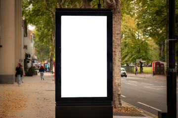 A blank advertising board on busy London street with space for copy, text or generative fill