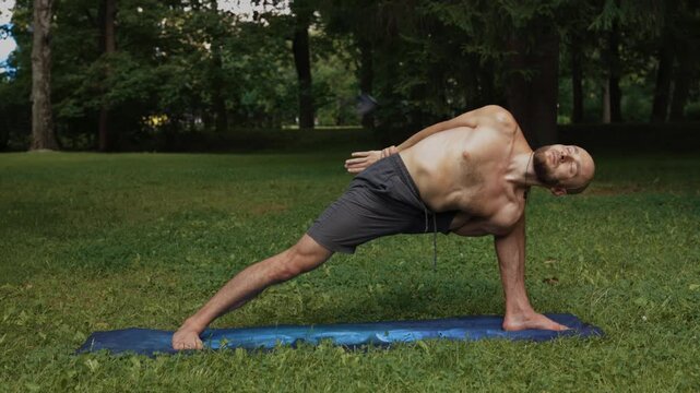Openair setting features man holding extended triangle pose