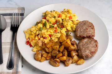 scramble eggs with sausage patties and  home fries