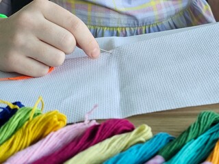 Hand sewing project in a cozy setting with colorful threads