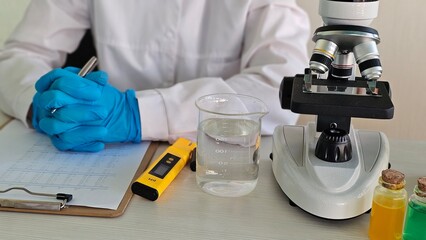 Scientist conducts research in a laboratory setting with a microscope, beakers, and data analysis concept