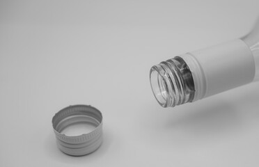 Aluminum screw cap and bottle neck. Tight seal, low oxygen tolerance, and quick to open. Minimalism. Black and white. 