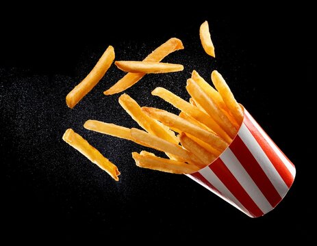 french fries isolated golden potato sticks flying in motion crispy texture delicious fast food snack crunchy bite appetizing side dish tasty finger food popular worldwide classic junk meal pe