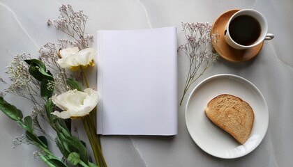 blank white magazine on marble table with coffee cup on white saucer and bread on plate flat lay photography with natural flowers on light background breakfast and leisure concept