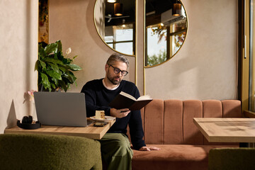 Mature man enjoys reading in a stylish cafe with modern decor and inviting atmosphere