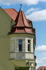Ornate bay window on a historic building in Wittenberg, Germany, featuring decorative elements and architectural details.