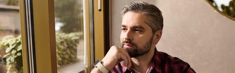 Mature man reflecting thoughtfully while enjoying a moment of peace indoors