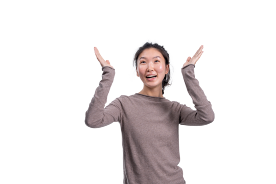 Happy Asian woman in casual sweater raising hands, realistic photo style, isolated on white background. Concept for joy, surprise or presentation