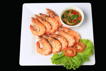 Fresh sea shrimp grilled over charcoal until cooked, served with Thai seafood sauce, Food photography for use in menus