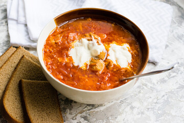 Delicious and aromatic red soup with meat, Ukrainian borscht with sour cream. Traditional Ukrainian dish, cuisine