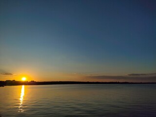 Vibrant Orange and Yellow Sky Reflection on Water