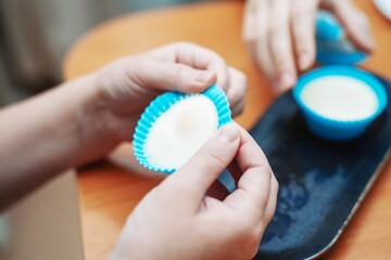 Removing a perfectly cooked poached egg from a silicone mold for breakfast