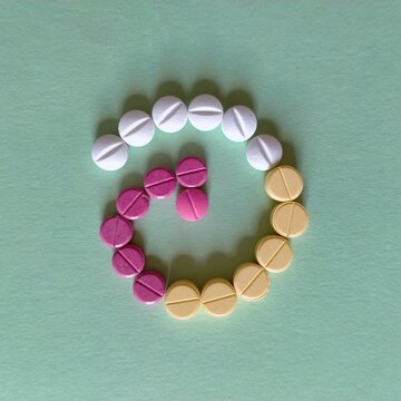 Pastillas m&eacute;dicas rojas amarillas  y blancas en forma de espiral