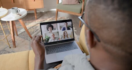 Man participating in a Video call Meeting at Home on Sofa