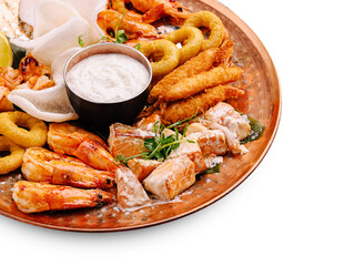 Delicious seafood platter featuring shrimp, fish, and dipping sauce
