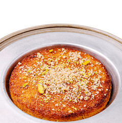 Delicious dessert featuring golden kunafa topped with nuts