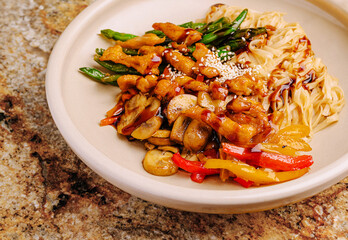 Delicious stir-fry with chicken, vegetables, and noodles served in a bowl